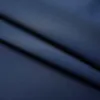 A close-up, angled view of dark blue fabric, likely curtains, showing folds and texture. Náhľad obrázku produktu