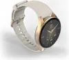 A smartwatch with a white strap and gold casing is shown against a white and light gray background. Voir les images du produit