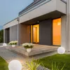 A modern house entrance with outdoor lighting and plants. Produktbild-Vorschau