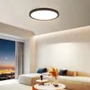 A modern living room with a large window overlooking a city at dusk, featuring a sleek ceiling light and a sectional sofa. Produktbild-Vorschau