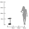 A scale drawing showing a small table next to a silhouette of a person, with measurement markings along the side and bottom. Voir les images du produit