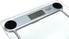 A close-up, angled view of a digital bathroom scale with a glass platform and a silver-colored display unit. Náhled obrázku produktu