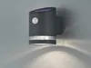 A dark gray, cylindrical solar-powered outdoor wall light with a motion sensor is mounted on a light gray wall, casting a downward light pattern. Anteprima dell’immagine prodotto