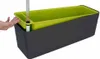 A hand is shown placing a green planter box into a gray outer planter box. Náhled obrázku produktu
