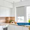 A modern kitchen with white cabinets, a wooden backsplash, and a window with a roller blind. Produktbild-Vorschau