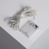 A battery-powered LED string light set is placed on a white surface. Produktbild-Vorschau