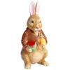 A ceramic figurine of a rabbit dressed in a brown jacket, holding a paint pot and an Easter egg. Náhled obrázku produktu