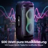 A portable party speaker is shown in a nighttime city setting with people dancing and colorful light waves emanating from the speaker. Produktbild-Vorschau
