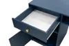 A close-up view of an open drawer on a dark blue desk. Podgląd zdjęcia produktu