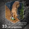 A golden retriever dog plays with a toy on a wooden deck and gravel area. Náhled obrázku produktu