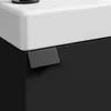 A close-up view of a black vanity cabinet with a white sink and a black handle. Voir les images du produit