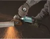 A person is using an angle grinder to cut a metal bar, creating sparks. Voir les images du produit
