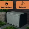 A storage box is shown outdoors next to some greenery and a textured wall. Produktbild-Vorschau