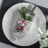 A Christmas-themed table setting with a plate, cutlery, napkin, and festive ornaments. Podgląd zdjęcia produktu