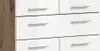 A close-up view of a white dresser with wood-effect side panels and silver handles. Produktbild-Vorschau