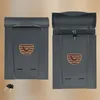 Two gray mailboxes are shown side-by-side against a light brown background. The mailbox on the right has its lid open, revealing a lock and key. Náhľad obrázku produktu