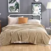 A bed with a blanket and pillows in a bedroom setting. Produktbild-Vorschau