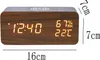 A digital alarm clock with a wood-grain finish is shown on a white background. Dimensions are indicated with text. Produktbild-Vorschau