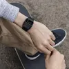 A person wearing a watch on a skateboard. Produktbild-Vorschau
