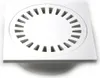 A white square drain cover with a circular grate pattern. Náhľad obrázku produktu