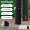 A black solar shower is shown outdoors on a wooden deck, with greenery in the background. Several feature callouts are present on the left side of the image. Produktbild-Vorschau