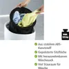 Hands are shown placing laundry into a white hamper with a black liner. Text and a weight icon are on the right side. Podgląd zdjęcia produktu