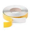 A roll of self-adhesive white foam tape with a yellow backing. Produktbild-Vorschau