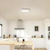 A modern kitchen with white cabinets and a wooden countertop, featuring a ceiling light. Produktbild-Vorschau