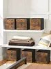 Storage boxes are neatly arranged on shelves in a room, with blankets and a pillow adding to the cozy atmosphere. Produktbild-Vorschau