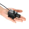 A hand holding a small black water pump. Náhľad obrázku produktu