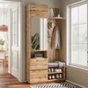 A compact wardrobe with a mirror, bench, and shoe storage in a hallway setting. Voir les images du produit