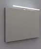 A bathroom cabinet with a light fixture above it, mounted on a gray wall. Voir les images du produit
