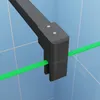 A close-up view of a black shower frame holding a green bar, set against a blue tiled background. Produktbild-Vorschau