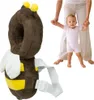 A baby is learning to walk with the help of an adult, while wearing a bee-shaped safety backpack. Podgląd zdjęcia produktu