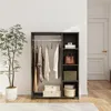 A dark gray wardrobe with clothes hanging on a rod and shelves with accessories and boxes. Náhled obrázku produktu