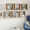 A set of six cube-shaped wall shelves mounted on a white wall, decorated with various items. Anteprima dell’immagine prodotto
