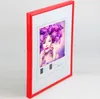 A red picture frame with a white mat and a picture of a woman with purple hair. Produktbild-Vorschau