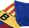 A close-up view of a folded fleece blanket with the FC Barcelona colors and logo. Produktbild-Vorschau