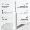 A white electric toothbrush is displayed on a marble surface with descriptive text and icons highlighting its features. Náhled obrázku produktu
