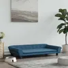 A blue dog bed is placed on a rug in a living room setting, with a plant and a painting on the wall. Náhled obrázku produktu