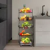 A multi-tiered storage rack filled with fruits and vegetables is placed in a modern kitchen setting next to a sink and faucet. Voir les images du produit
