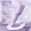 A purple hair curler is displayed on a stand, with callouts highlighting its features. Produktbild-Vorschau