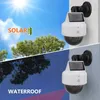 A split image showing a solar-powered dummy security camera in two different weather conditions: sunny and rainy. Produktbild-Vorschau