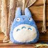 A plush Totoro toy sits on a wooden surface, leaning against a crocheted blanket. Anteprima dell’immagine prodotto