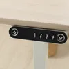 Close-up of a modern adjustable height desk's control panel and tabletop. Náhled obrázku produktu