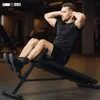 A man is doing sit-ups on an adjustable weight bench in a gym. Produktbild-Vorschau