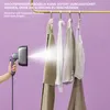 A hand holding a garment steamer sprays steam onto clothes hanging on a rack. Text overlays provide product information. Produktbild-Vorschau