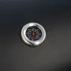 A close-up shot of a thermometer on a black surface. Podgląd zdjęcia produktu