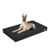 A Great Dane dog lying on a black dog bed against a white background. Produktbild-Vorschau