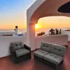 A balcony overlooking the ocean at sunset, with outdoor furniture. Produktbild-Vorschau